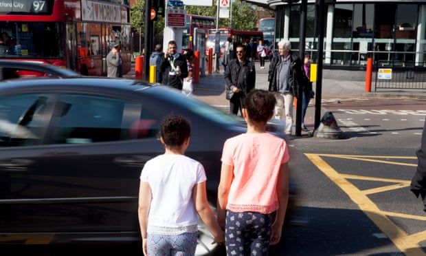 Children stand by a busy London road