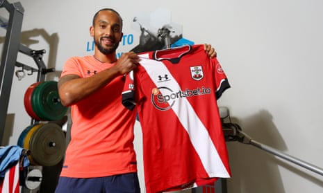 Theo Walcott poses with a Southampton shirt after rejoining the club on a season-long loan deal from Everton.