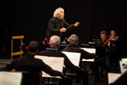 Sir Simon Rattle conducts the physically distanced City of Birmingham Symphony Orchestra in the streamed performance.