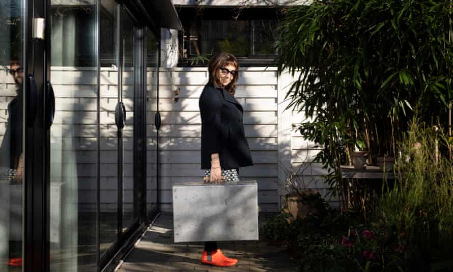 Case study … Calle in her garden with the suitcase of relics.