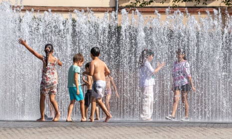 Children play in a fountain