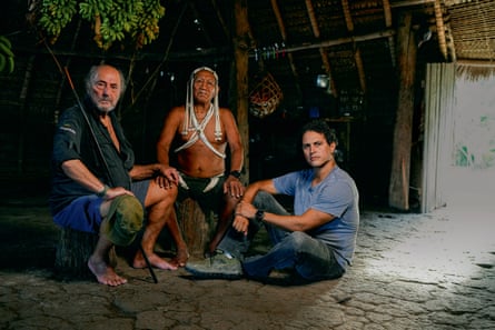 Posed shot of Sydney Possuelo, left, and his son Orlando with Estevao, chief of the Marubos (in traditional dress), one of the seven peoples of the Javari valley.