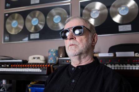 Close up of Millar wearing sunglasses with gold records on the wall behind him