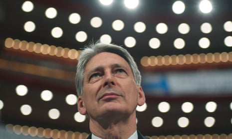 Philip Hammond watches Theresa May deliver her Brexit speech at the Conservative party conference on 2 October, 2016.