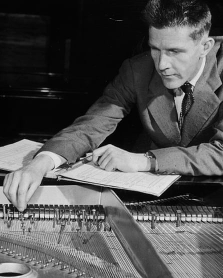 John Cage changing the tuning of his piano by placing coins and screws between the strings, in Paris in 1949.