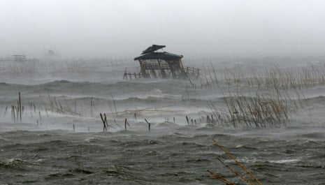 A view of a fisherman’s house in the middle of a fish pen as it is pounded by waves, heavy winds and rain brought by Typhoon Rammasun (locally named Glenda) as it hit the coastal town of Bacoor, Cavite southwest of Manila, July 16, 2014. Global warming is causing more extreme precipitation.