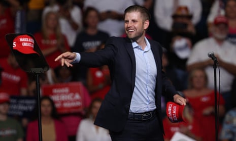 Eric Trump tosses a hat into the crowd at the Tulsa rally on Saturday