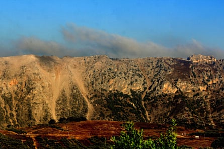View of hills covered with yellow dust with dark grey clouds behind them. View of hills covered with yellow dust with dark grey clouds behind them.
