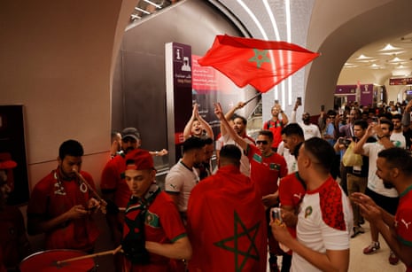 Morocco fans with flag and drum gather at the red line at Msheireb metro station before heading to their game against Canada.