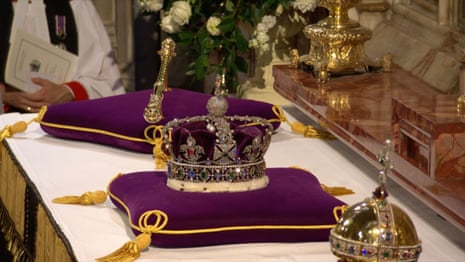 The orb, sceptre and imperial state crown are removed from the top of the coffin and placed on the altar.