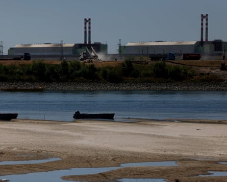 Exposed sandbanks in foreground with the nuclear power plant seen across the reduced flow of the Danube