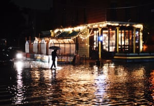 A person walks on a flooded street in Ditmas Park