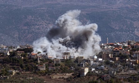 Smoke rises above houses on a hillside