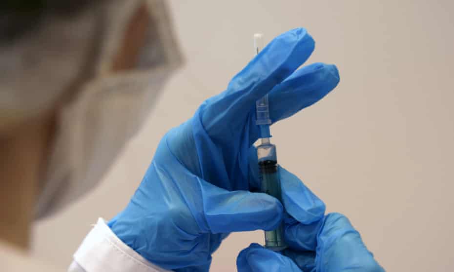 A medic prepares a dose of the coronavirus vaccine.