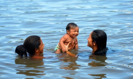 Woman with baby in the river Rio Tapajos.