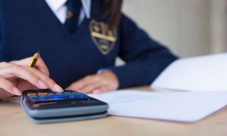A senior school pupil uses a calculator