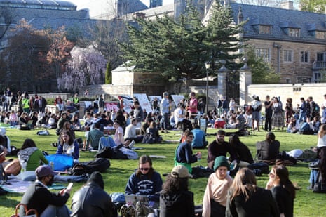students sit on grass