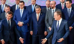 Emmanuel Macron, left, and Donald Tusk, right, gesture toward an empty space at the front of the European leaders, minus Theresa May, at last week’s European Council summit in Brussels.
