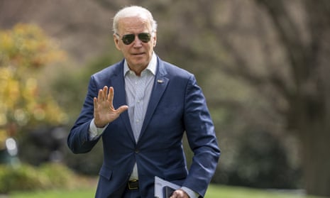 Joe Biden waves to the press after walking off Marine One on the South Law of the White House after returning from a weekend in Delaware in Washington DC.