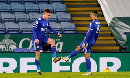 Harvey Barnes of Leicester City celebrates with teammate Youri Tielemans, touching boots to maintain social distancing measures.
