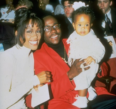 Pop singer Whitney Houston with singer husband Bobby Brown, who is holding their infant daughter Bobbi