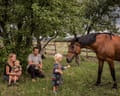 A child feeds a horse in Ukraine. From the series 5K from the Frontline.