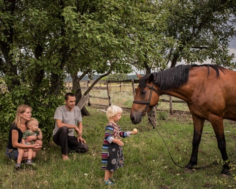 A child feeds a horse in Ukraine. From the series 5K from the Frontline.