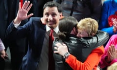 Anas Sarwar celebrates with Maureen Burke (in red) being hugged by woman