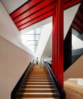 Dynamic descent … the staircase wraps around red steel beams.