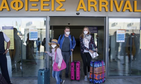 Tourists, arrive at Heraklion airport in Crete. Travellers returning from the island and six others to England will have to quarantine from Wednesday