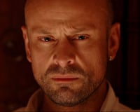 Closeup on face of Tony Cook looking mean.