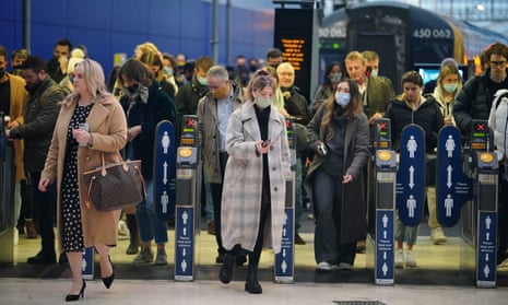 Commuters at Waterloo station, London, after plan B measures were lifted in England, 27 January 2022