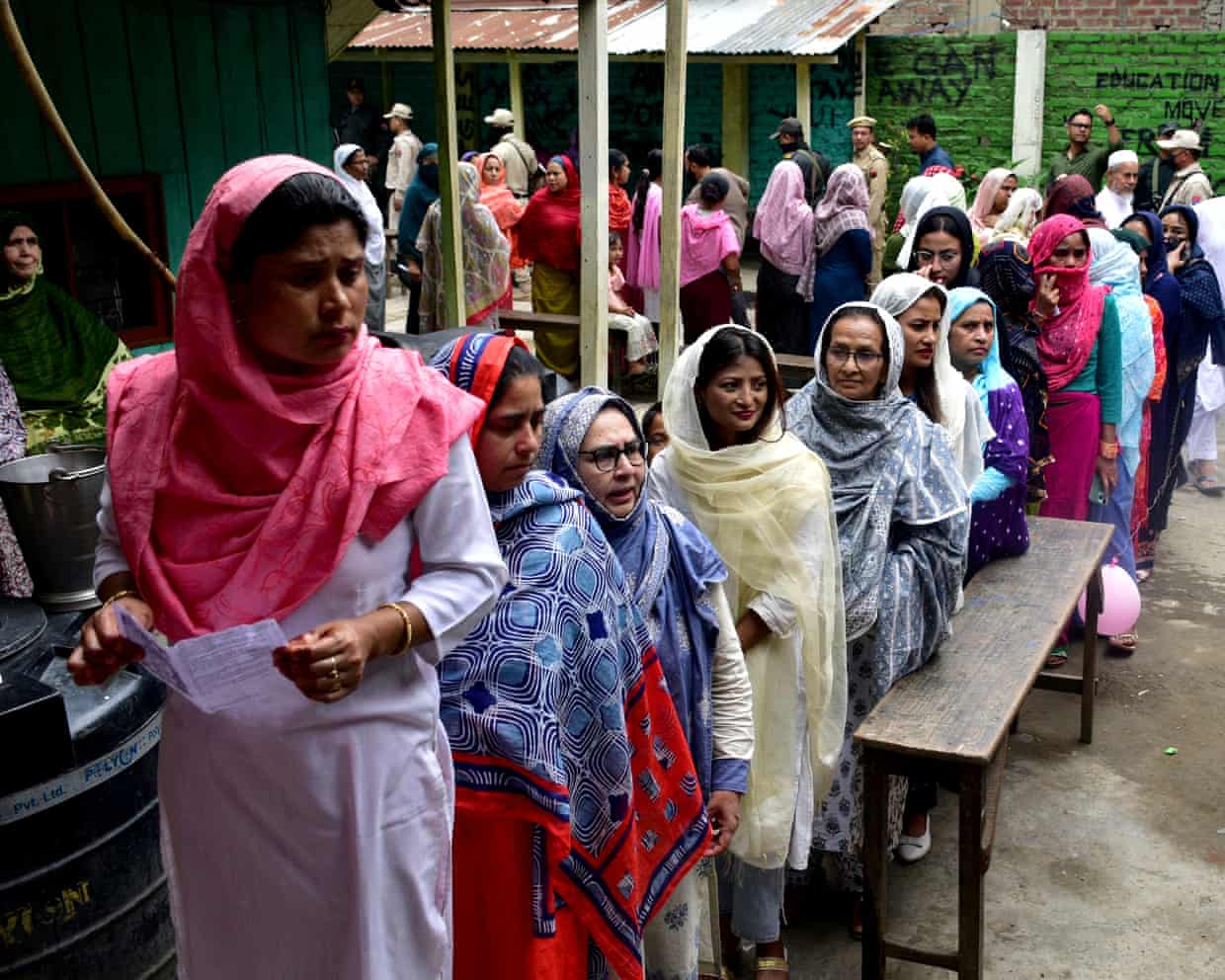 Women wait to cast their votes at a polling station during the first phase of the general election, in Imphal, Manipur, India