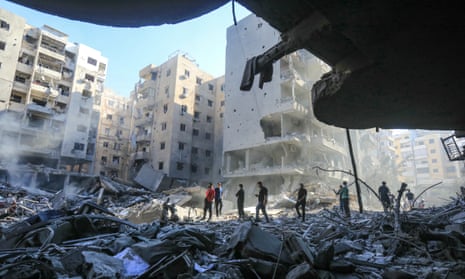 People walk amid the rubble of buildings levelled by Israeli strikes that killed Hezbollah leader Hassan Nasrallah in the Haret Hreik neighbourhood of Beirut's southern suburbs.