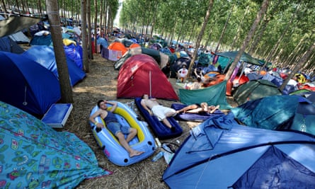 Festival goers sleep among tents at the EXIT festival camp near the Serbian city of Novi Sad