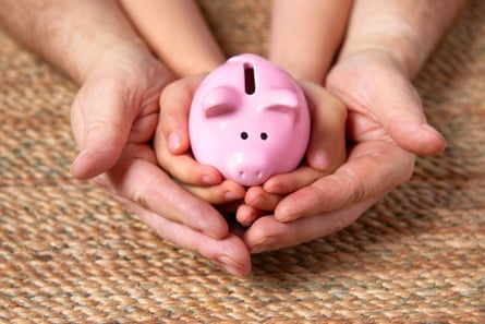 Father and child holding piggy bank