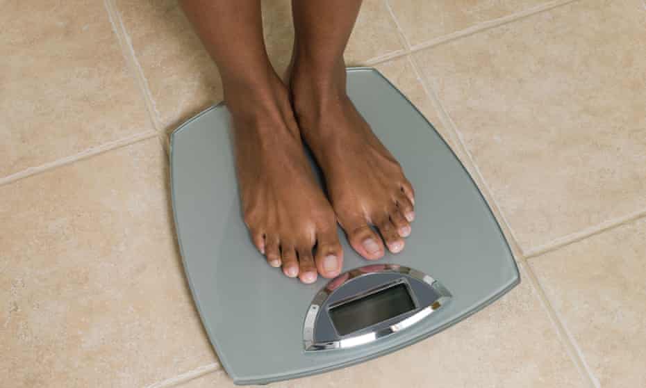 Feet of woman on scales.