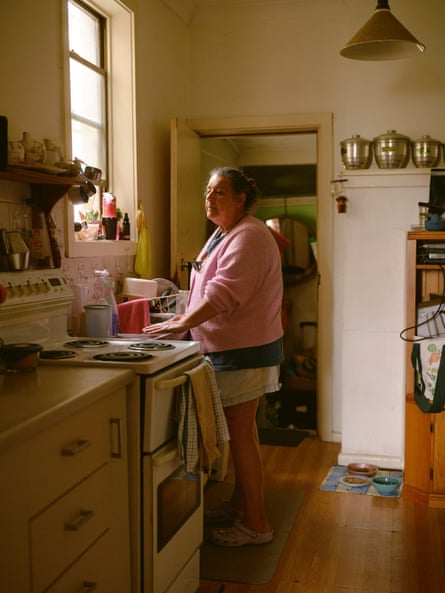 Ellen Rogers stands facing a window in her mother's kitchen