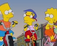 a screengrab of three animated characters from The Simpsons riding bikes