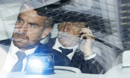 Sarkozy (right) is driven away from court in Paris