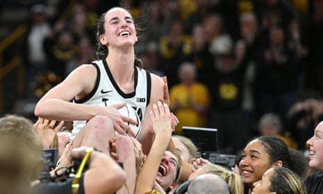 Iowa Hawkeyes guard Caitlin Clark is hoisted aloft by her teammates after breaking the NCAA women’s all-time scoring record on Thursday against the Michigan Wolverines at Carver-Hawkeye Arena.