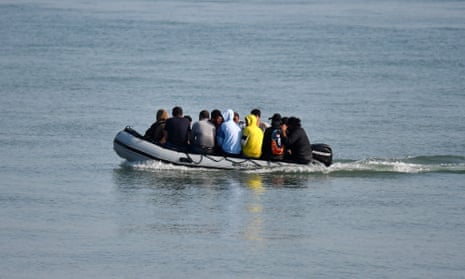 Migrants travel by inflatable boat as they reach the shore near Deal on the south east coast of England.