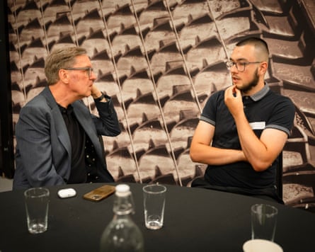 Alan Milburn and Callum Beeston sit at a table together talking