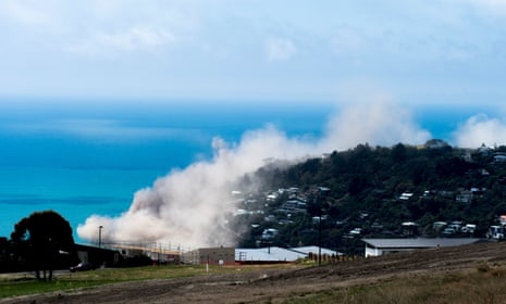 Dust and debris rise above houses after a cliff collapsed due to an earthquake above Scarborough Beach in the suburb of Sumner in Christchurch.