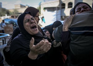 Women weeping as bodies of Palestinians who lost their lives in an Israeli airstrike targeting the Gazzat family home in the Es-Sabra neighborhood are taken from Al-Shifa Hospital for funeral prayers in Gaza City