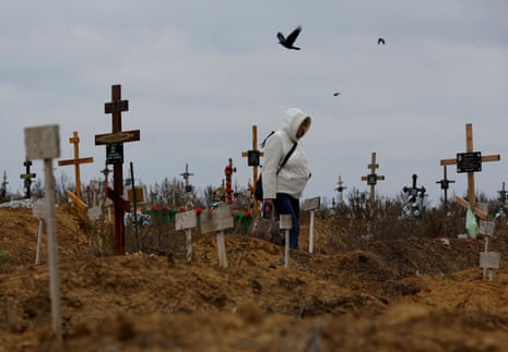 A woman visits a cemetery outside Mariupol in Russian-occupied Ukraine.