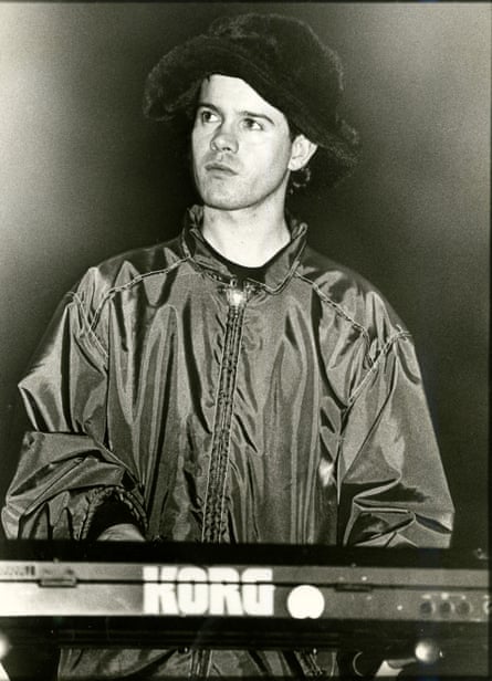 Black and white photo of Duffy in a zip-up anorak and floppy hat playing a Korg synthesiser