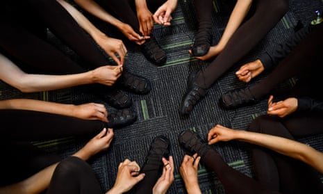 Dancers tie the laces of their dancing shoes before the 2022 World Irish Dancing Championships in Belfast.