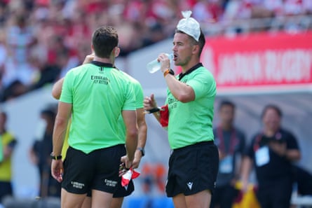 Touch judge Luke Pearce puts an ice bag on his head and drinks water during the rugby international match between Japan and Wales in Kitakyushu earlier this month