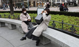 Tourists wearing protective masks in Milan, Italy.